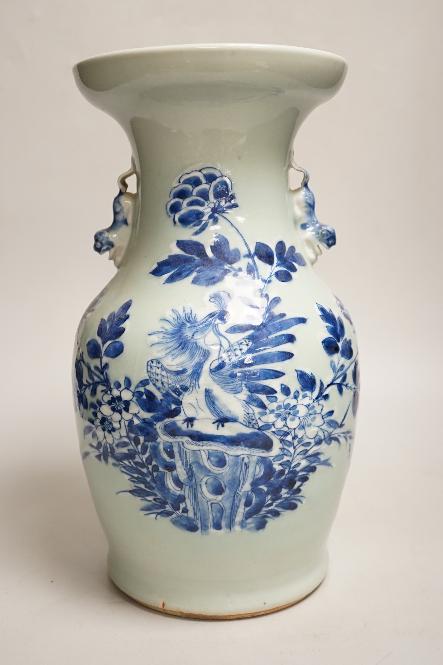 A Chinese celadon ground underglaze blue baluster vase, early 20th century, 34cm